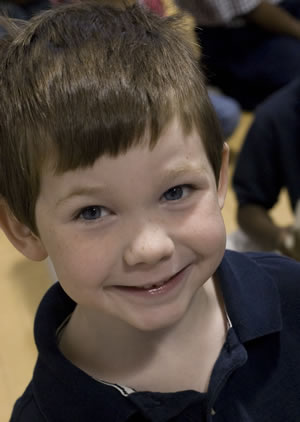 A photo of a boy smiling.